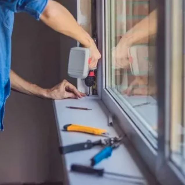 A person repairs a window using a tool, demonstrating a hands-on approach to home maintenance.