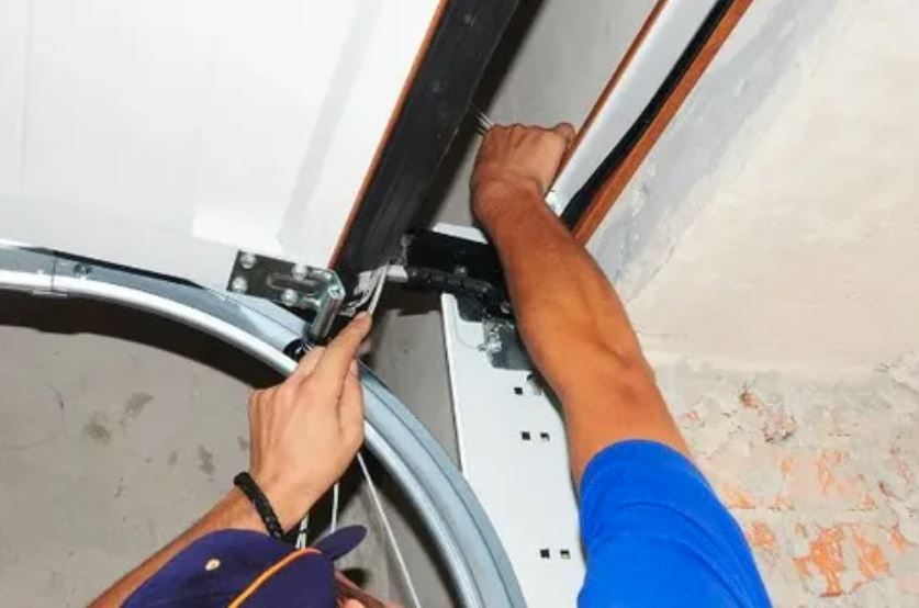 Garage door repair service in Miami, showcasing a technician fixing a residential garage door.