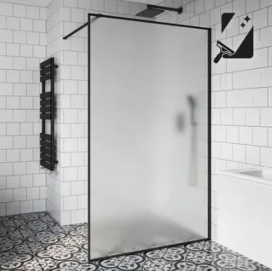 A modern bathroom featuring a sleek black shower screen and a spacious shower area.