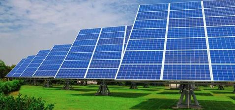 Solar panels installed on a vast field, harnessing sunlight for renewable energy generation.