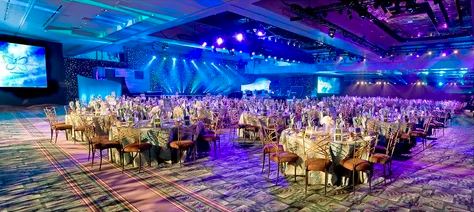 A spacious ballroom arranged with elegant tables and chairs, ready for a grand banquet event.